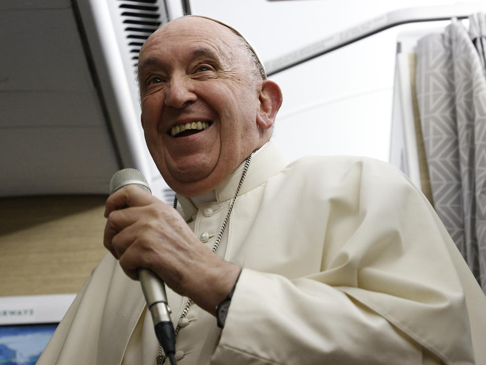 Pope Francis speaks to journalists aboard the papal flight back from Canada on Saturday.