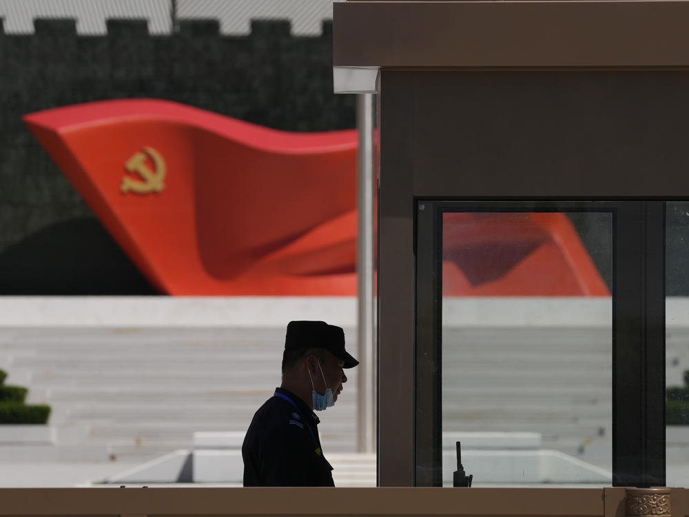 A security guard stands near a sculpture of the Chinese Communist Party flag at the Museum of the Communist Party of China on May 26, 2022, in Beijing. China said it was conducting military exercises Saturday, off its coast opposite Taiwan.