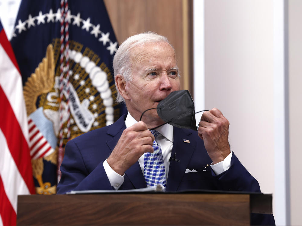 President Biden takes his face mask off on Thursday during a meeting on the U.S. Economy with CEOs and members of his Cabinet in the South Court Auditorium of the White House.