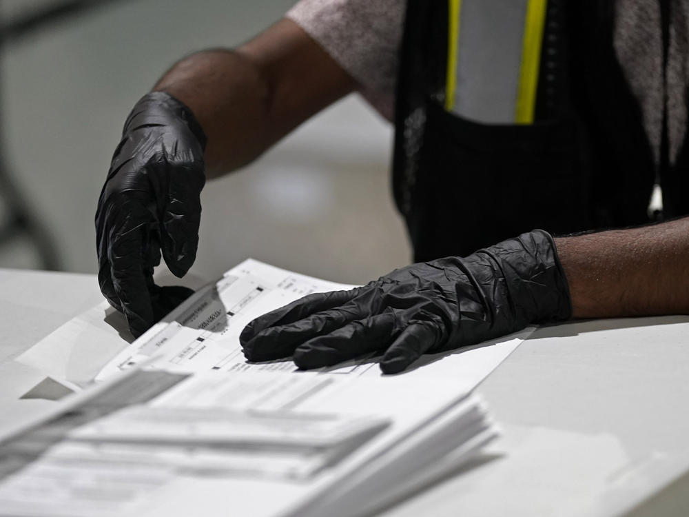 In this Sept. 3, 2020, file photo, a worker prepares absentee ballots for mailing at the Wake County Board of Elections in Raleigh, N.C.