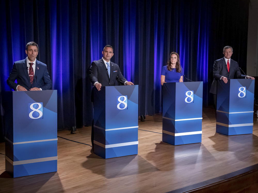 Michigan Republican candidates for governor Ryan Kelley, from left, Garrett Soldano, Tudor Dixon and Kevin Rinke appear at a debate in Grand Rapids, Mich., July 6, 2022.