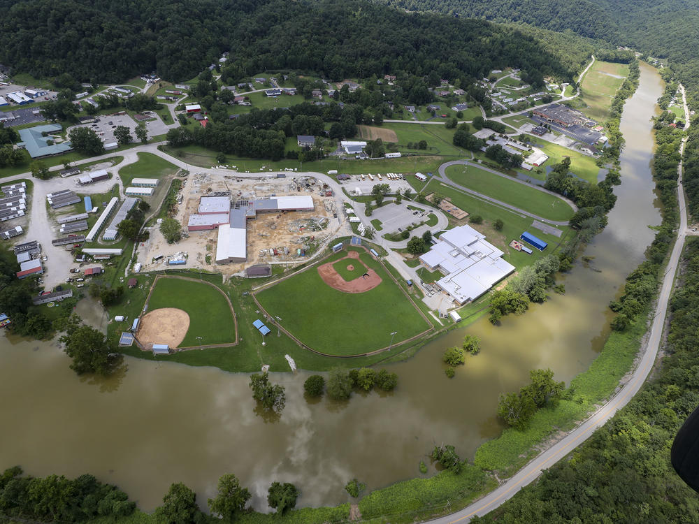 In this aerial image, the river is still high around the homes in Breathitt County, Ky., on Saturday. Recovery has begun in many of the narrow hollers after historic rains flooded many areas of Eastern Kentucky.