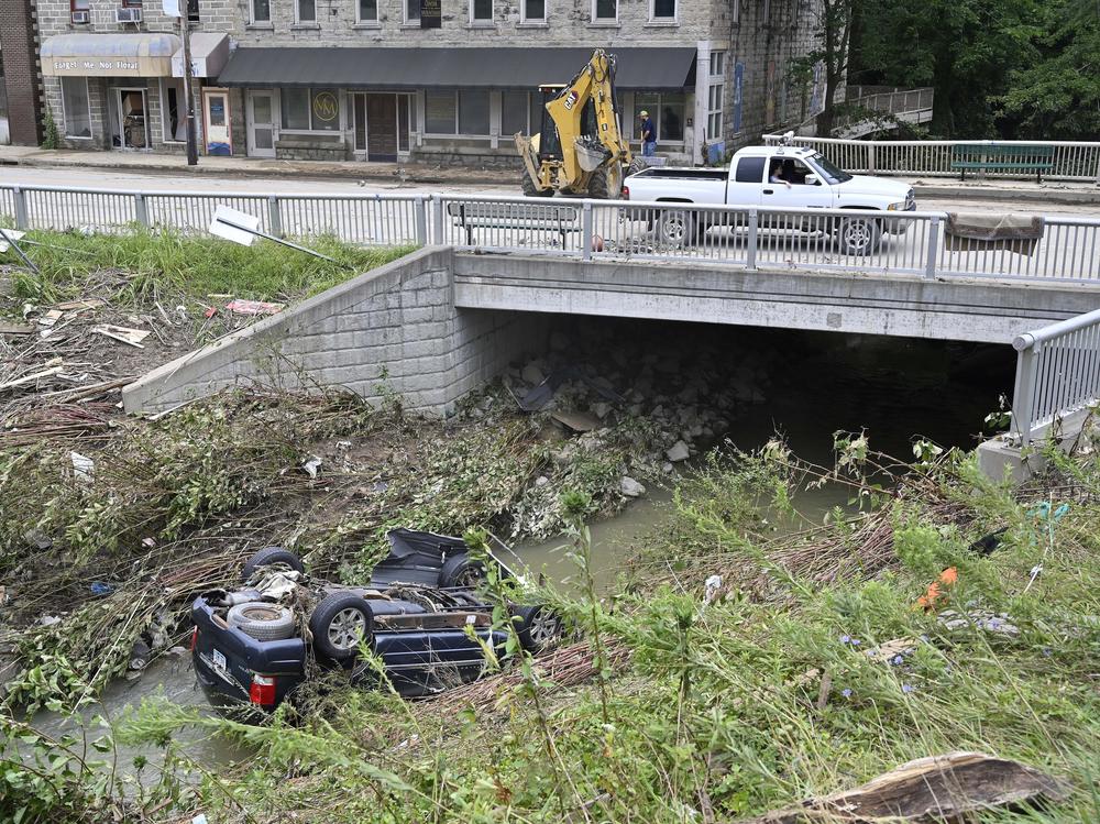 A car lays overturned in Troublesome Creek in downtown Hindman, Ky., on Sunday.