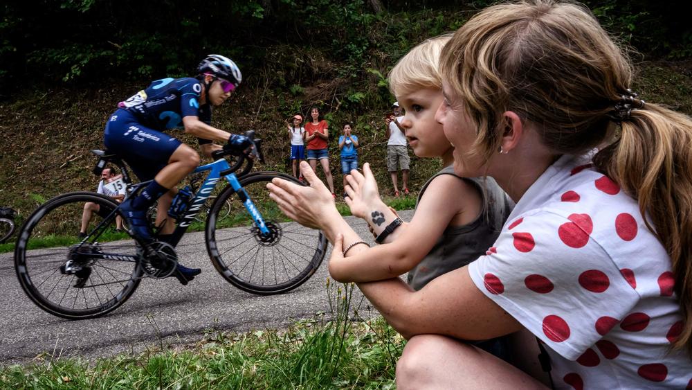 Fans watch from the roadside as Movistar cyclist Paula Andrea Patino of Colombia rides in the seventh stage of the Tour de France Femmes avec Zwift.