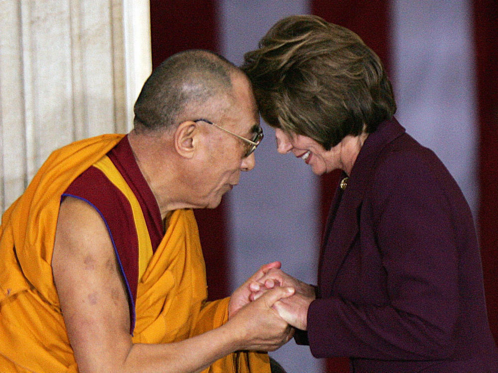 This 2007 photograph shows the 14th Dalai Lama of Tibet greeting House Speaker Nancy Pelosi during a ceremony to award the Tibetan spiritual leader the Congressional Gold Medal.
