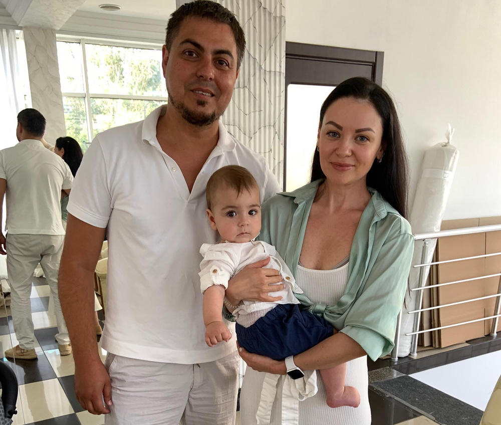 Wedding dress designer Yana Bashmakova, holding son Adam, runs the Ukrainian wedding dress company Giovanna Alessandro along with her husband Alexandr Marandyuk.