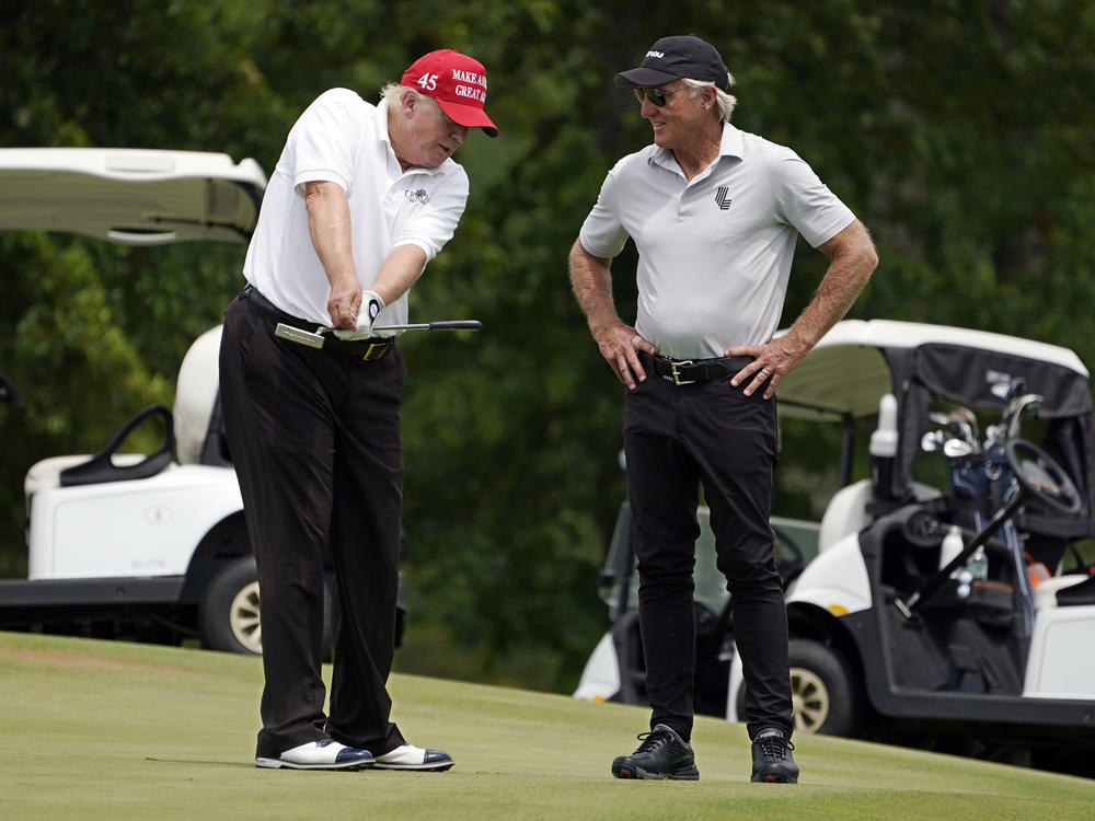 Former President Donald Trump talks with LIV Golf CEO Greg Norman on a green during the pro-am round of the Bedminster Invitational LIV Golf tournament on Thursday.