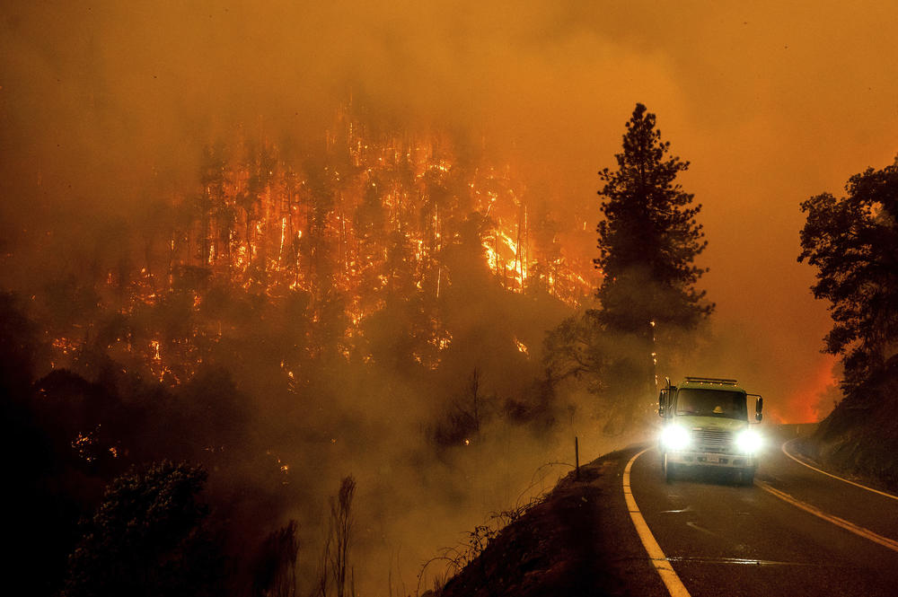 A firetruck drives along California Highway 96 as the McKinney Fire burns in Klamath National Forest on Saturday.