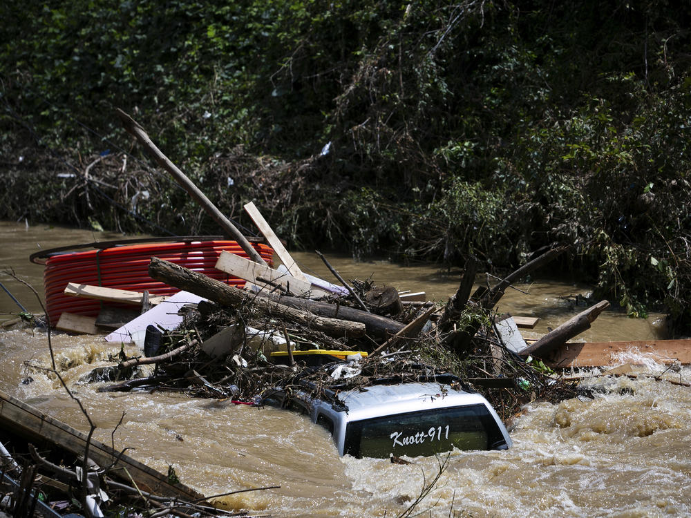 A truck is washed away by floodwaters in the Troublesome Creek near Main Street, in Hindman, Ky., on Monday.
