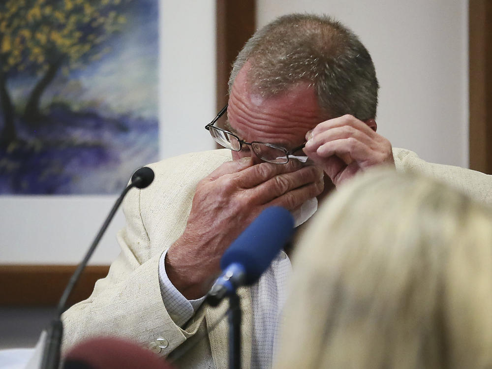 Neil Heslin, father of 6-year-old Sandy Hook shooting victim Jesse Lewis, becomes emotional while testifying in the trial of Alex Jones on Tuesday in Austin, Texas.