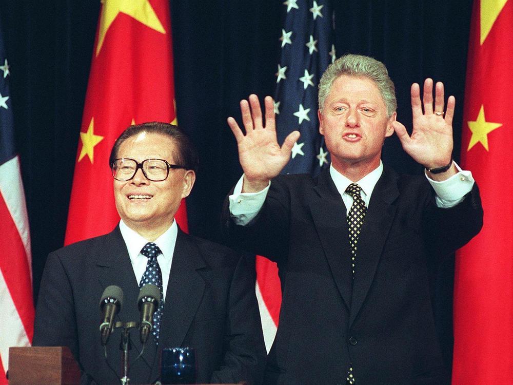 President Bill Clinton holds up his hands indicating no more questions as he and Chinese President Jiang Zemin hold a joint press conference in 1997 in Washington, D.C. Clinton confirmed that he agreed to lift a ban on the export of nuclear power technology to China.
