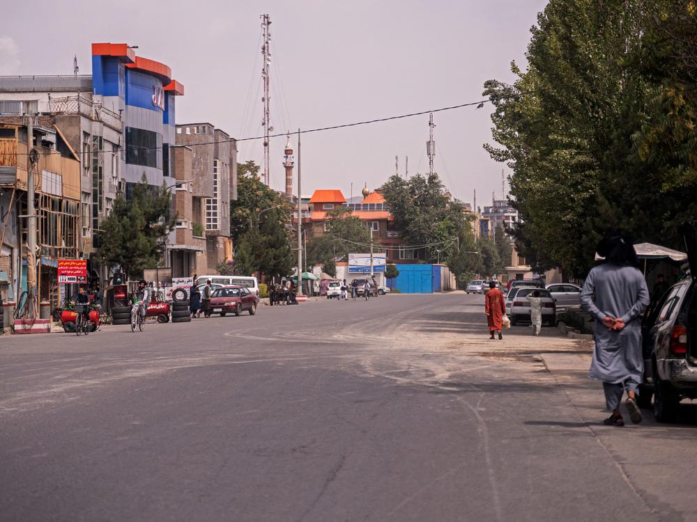 People walk through a road in the Sherpur area of Kabul, where Ayman al-Zawahiri lived, on Tuesday.