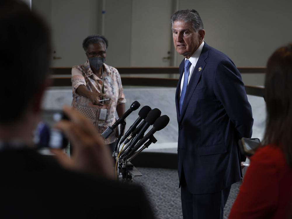 Sen. Joe Manchin, Democrat of West Virginia, speaks to reporters about the compromise bill that could substantially alter a tax provision called the 