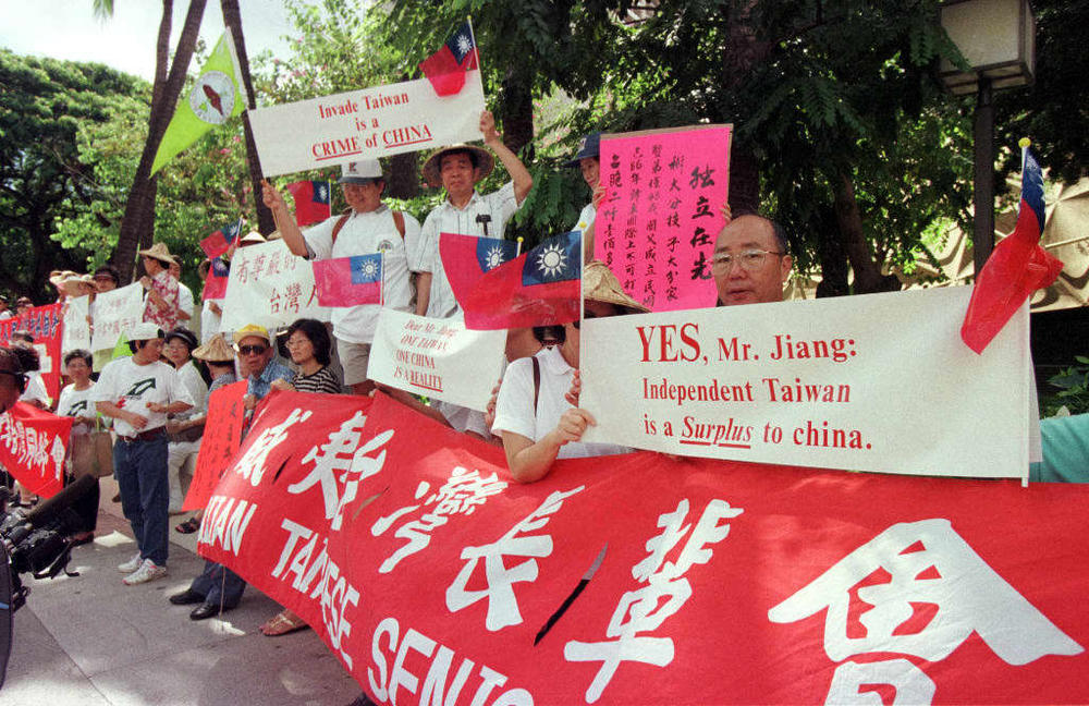Protesters hold signs and banners outside Honolulu's Hilton Hawaiian Village hotel, where Chinese President Jiang Zemin attended a luncheon with the mayor of Honolulu in 1997. The demonstrators shouted 