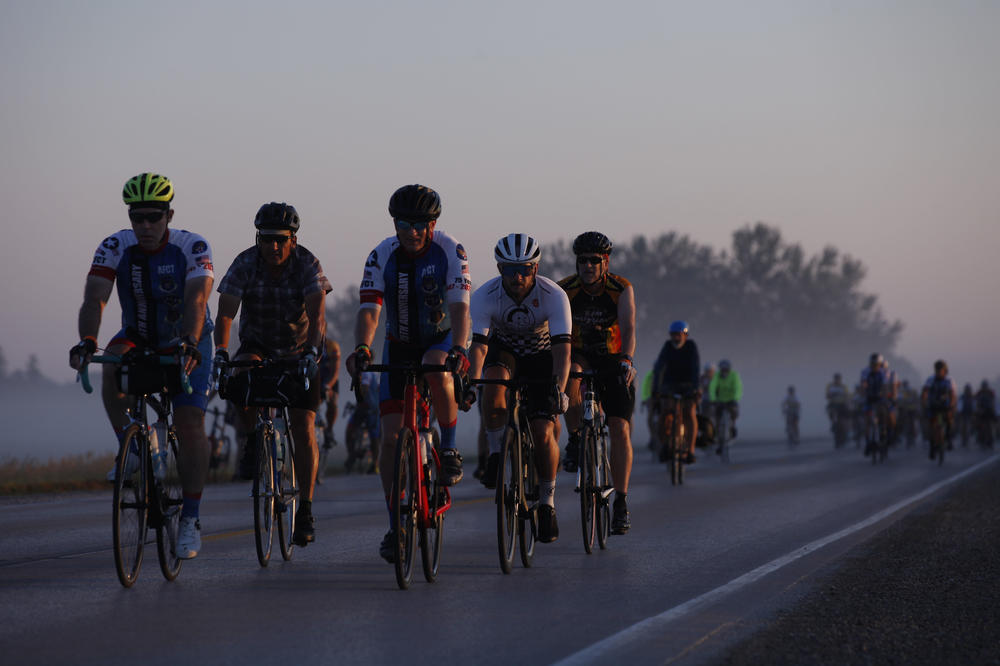 A group pf riders makes their way through the early morning fog Wednesday, July 28, as they make their way out of Emmetsburg, Iowa, on Day 4 of RAGBRAI. Riders travelled more than 100 miles that day, completing a 