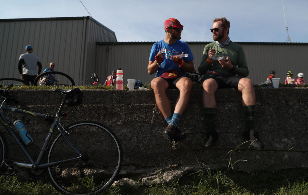 Alex Brooks of Minneapolis, Minn., (left) and Tim Connors of Robinsdale, Minn., eat slices of pie Tuesday, July 26, during a pit stop in Rolfe, Iowa. Connors said they were trying to eat a different slice of pie every day, with strawberry rhubarb, a childhood favorite, ranking as his top slice so far. 