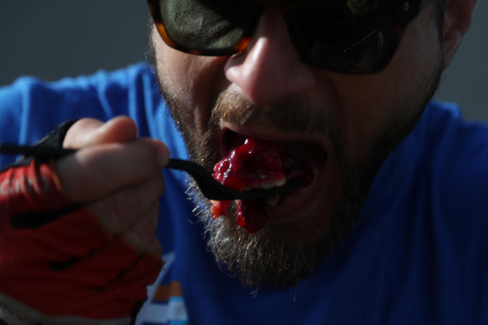 Alex Brooks of Minneapolis, Minn., takes a bite of his cherry pie Tuesday, July 26, during a pit stop in Rolfe, Iowa.