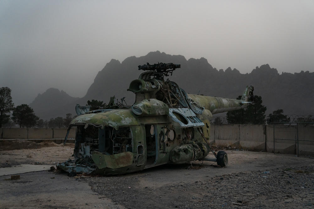 A destroyed helicopter sits in a corner of Yaqoob's compound.