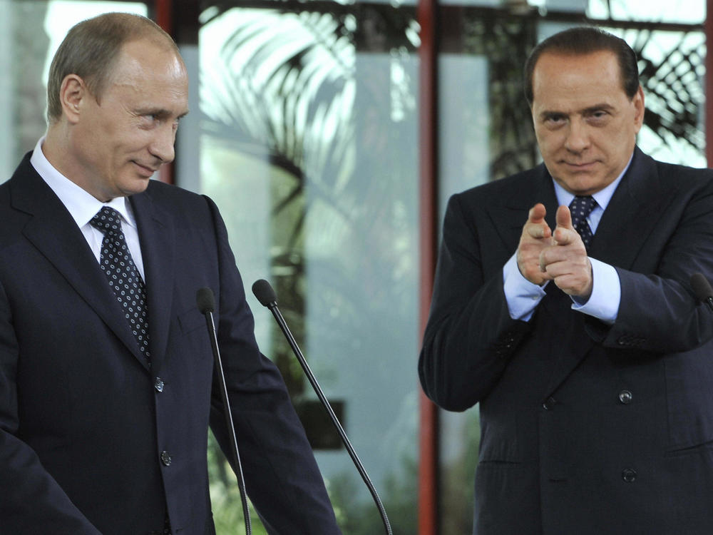 Silvio Berlusconi pretends to shoot at a journalist during a press conference with Russian President Vladimir Putin in April 2008. The journalist had asked Putin about rumors of his relationship with Alina Kabaeva.