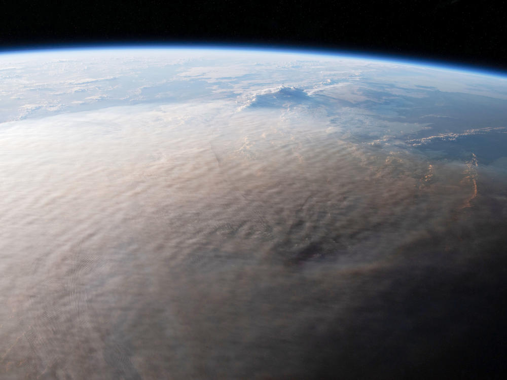 One day after an intense eruption by the Hunga Tonga-Hunga Ha'apai volcano, an astronaut on the International Space Station took this photograph of the gargantuan plume.
