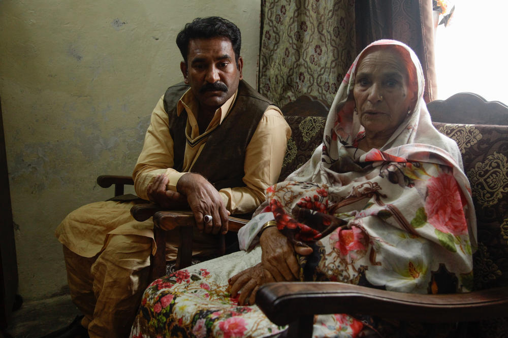 Sharifa Bibi sits with her son Altaf Hussain, who is helping her find her brother Mohammed Tufail, who was lost during the chaos of Partition in 1947.