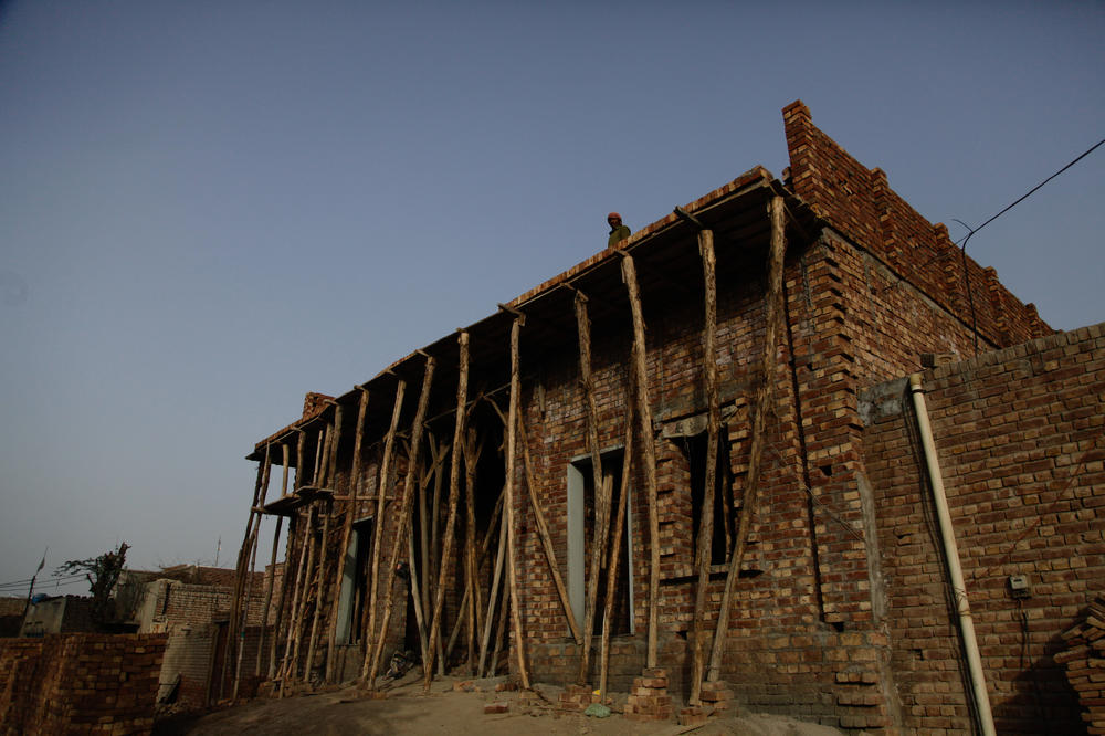 A house under construction in the village of Mohammed Asghar, who helped an Indian visitor named Ranjeet look for his family 35 years ago. Asghar believes the man was Sharifa Bibi's brother.