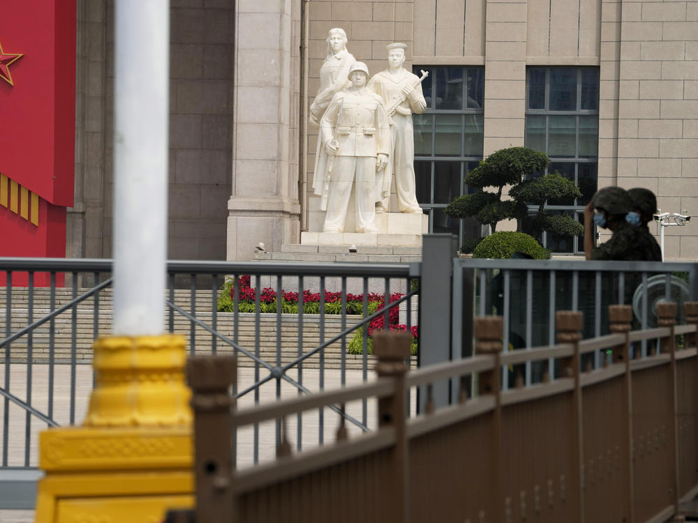 Chinese soldiers wearing masks guard the entrance to the military museum in Beijing on Aug. 1. China says military exercises by its navy, air force and other departments are underway in six zones surrounding Taiwan.