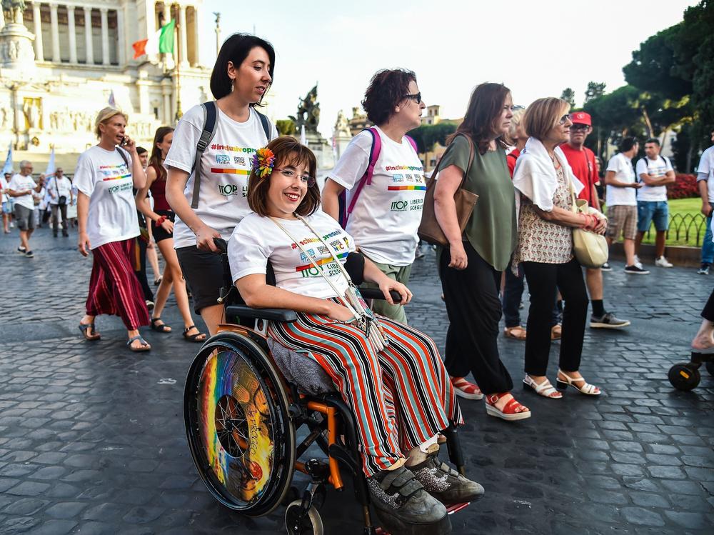 People take part in a disability pride parade on July 14, 2019, in central Rome.