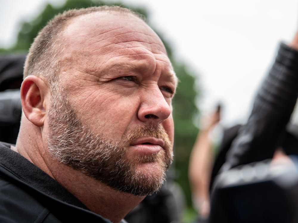 Infowars founder Alex Jones listens to a supporter at the Texas State Capital building on April 18, 2020 in Austin, Texas.