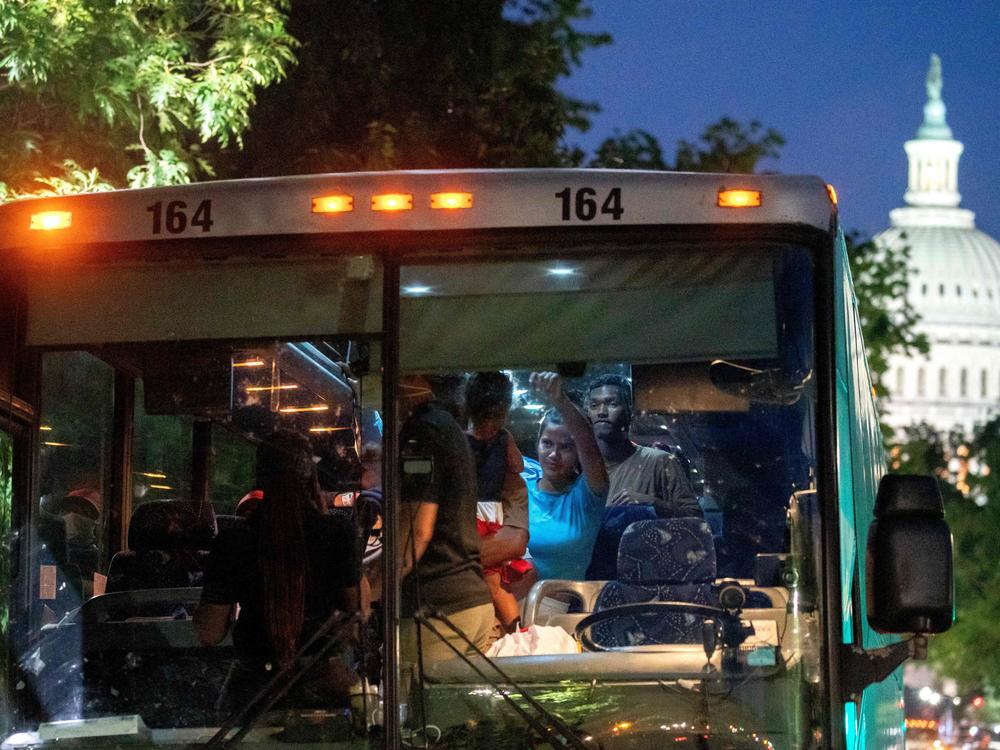 Migrants from Venezuela, who boarded a bus in Del Rio, Texas, disembark within view of the US Capitol in Washington, D.C., on Tuesday.