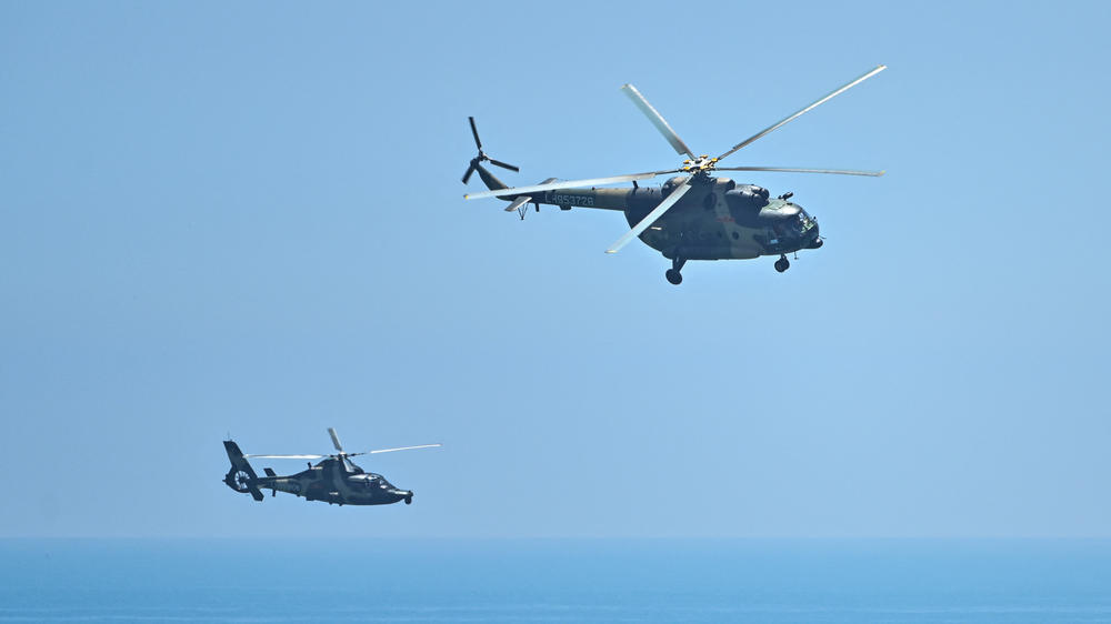 Chinese military helicopters fly past Pingtan island, one of mainland China's closest points to Taiwan, in Fujian province on Thursday.