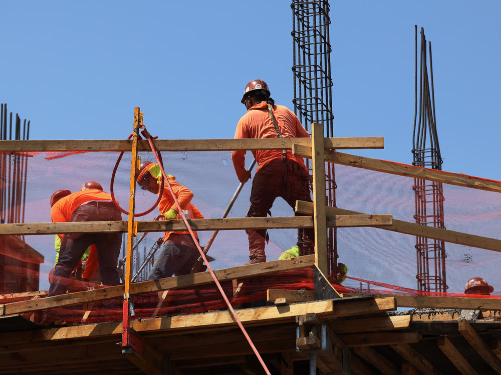 Construction workers work on a construction site in Brooklyn, N.Y., on July 22.