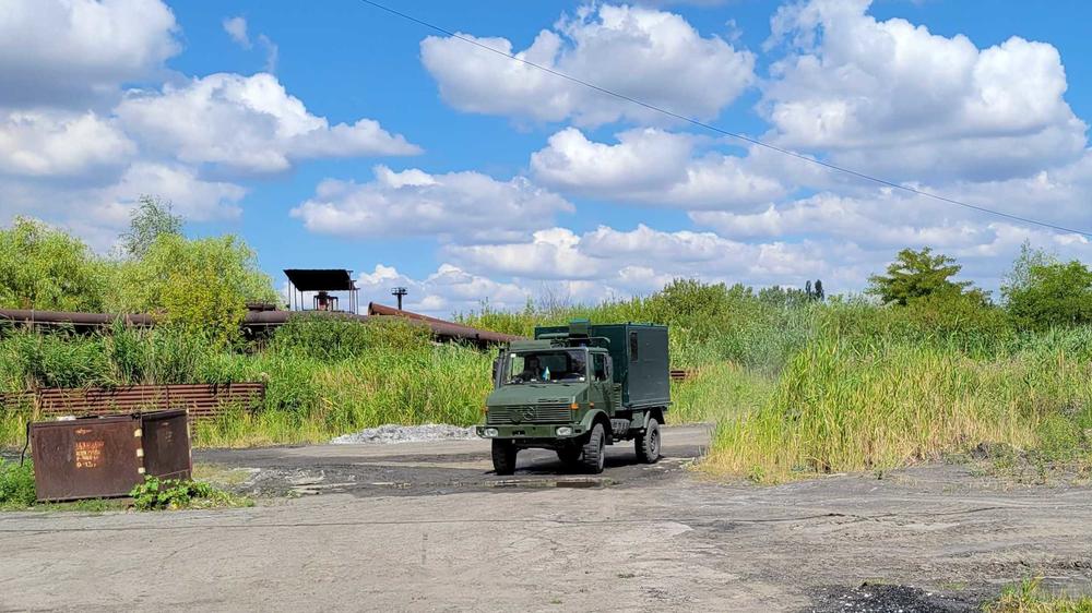 A Ukrainian ambulance drives to a rendezvous point near an abandoned factory in the 