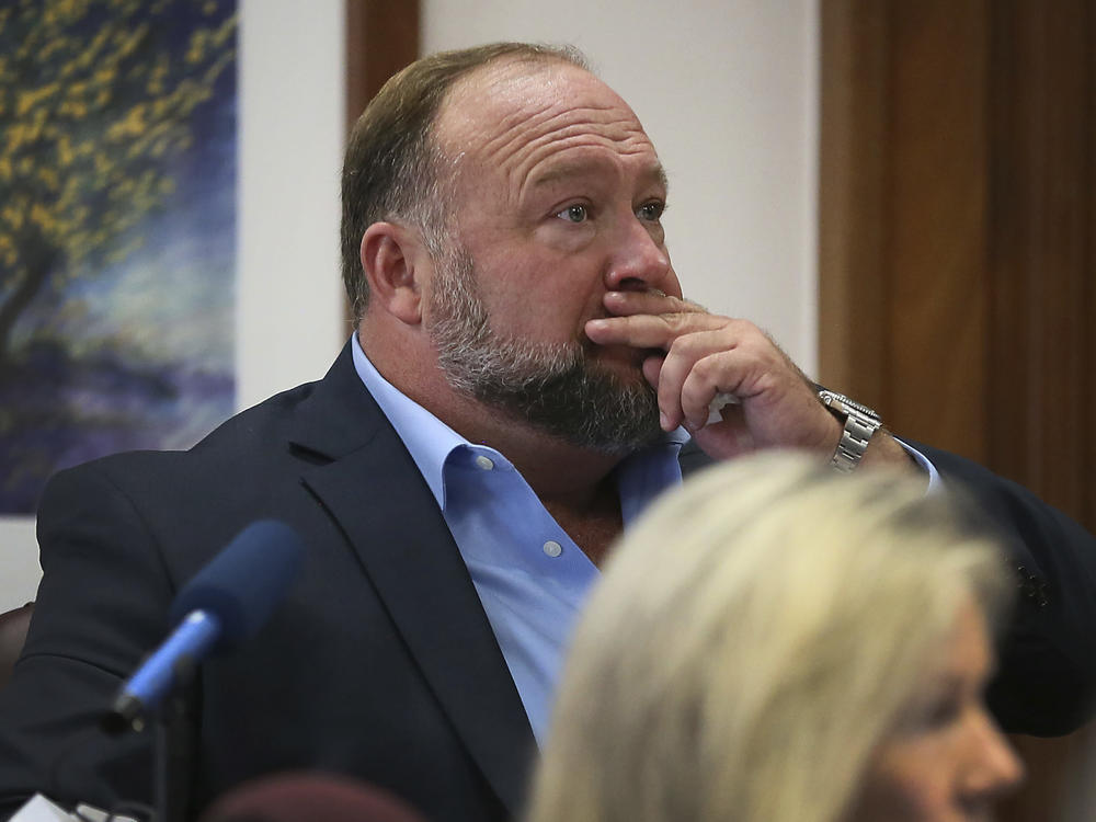 Alex Jones attempts to answer questions about his text messages during the Sandy Hook trial in Austin, Texas, on Wednesday.