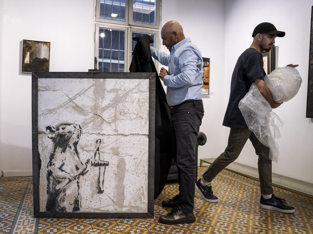 A painting by the secretive British graffiti artist Banksy that was mysteriously transferred from the occupied West Bank to the Urban Gallery in Tel Aviv, Israel, is shown on Thursday, Aug. 4, 2022.