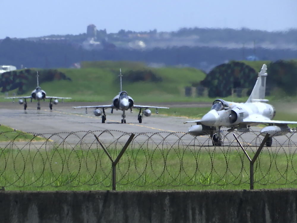 Taiwan Air Force Mirage fighter jets taxi on a runway at an airbase in Hsinchu, Taiwan, on Friday. China says it summoned European diplomats in the country to protest statements issued by the Group of Seven nations and the European Union criticizing threatening Chinese military exercises surrounding Taiwan.