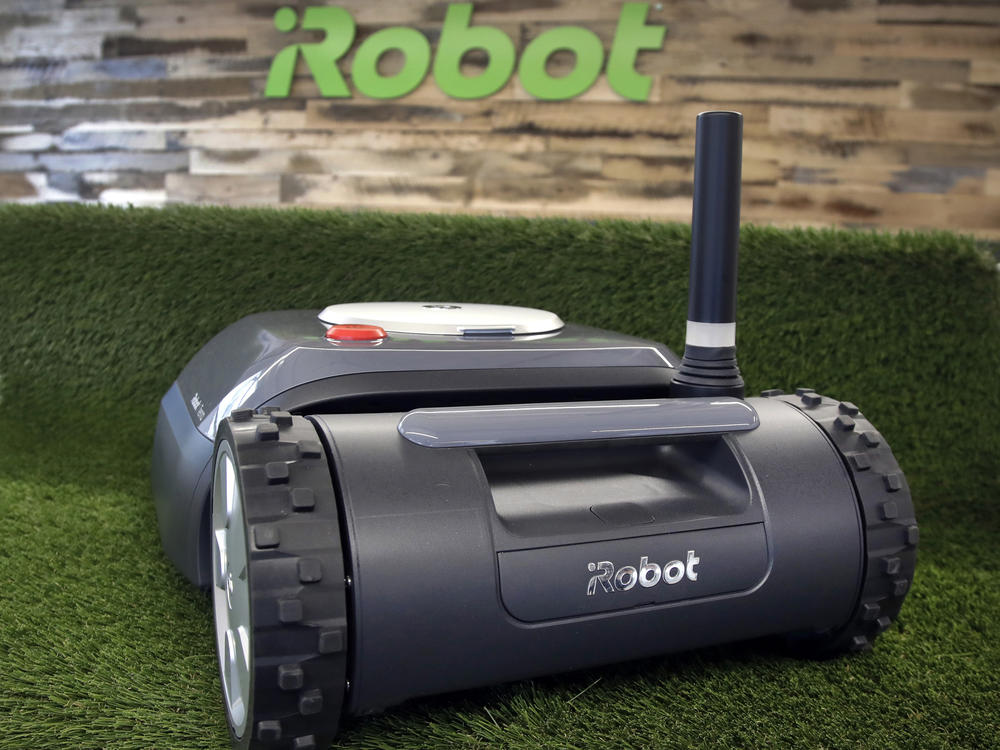An iRobot Terra lawn mower is shown in Bedford, Mass., on Jan. 16, 2019. Amazon on Friday announced an agreement to acquire iRobot for approximately $1.7 billion. iRobot sells its robots worldwide and is most famous for the circular-shaped Roomba vacuum.