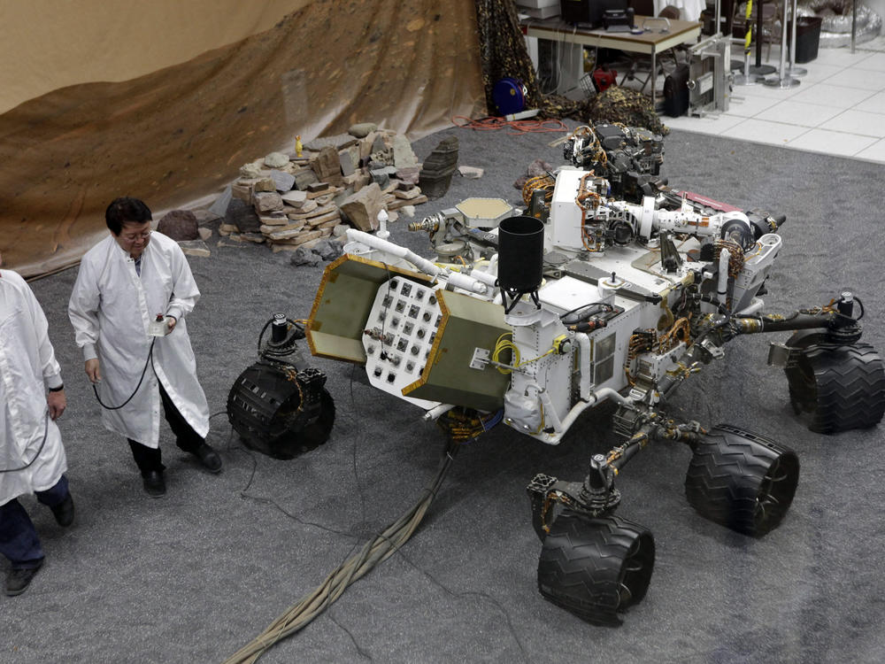 Engineers work on a model of the Mars rover Curiosity at the Spacecraft Assembly Facility at NASA's Jet Propulsion Laboratory in 2012.