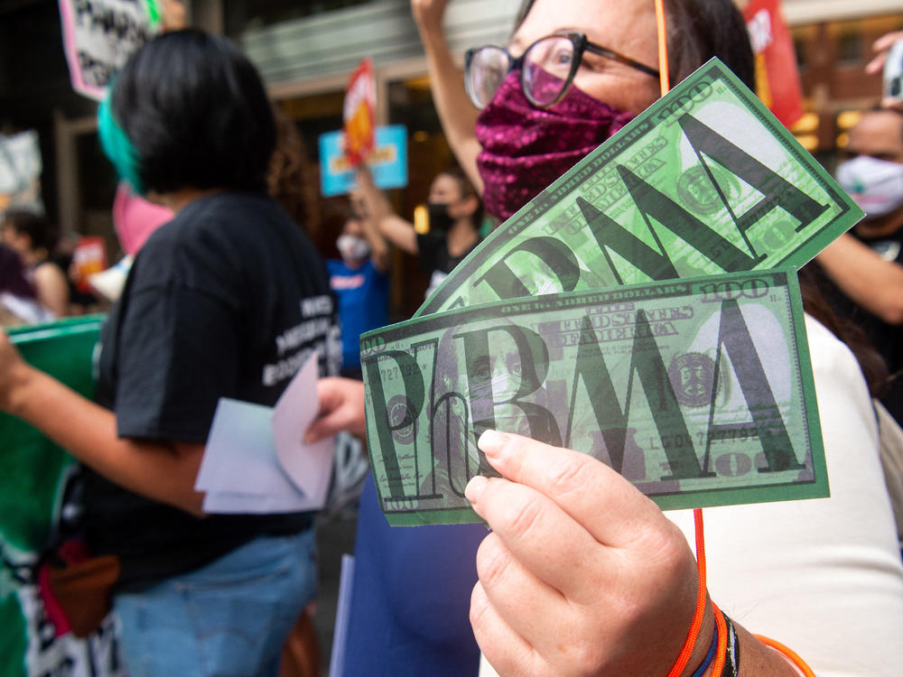 Demonstrators outside PhRMA headquarters in Washington, D.C., protest lobbying by pharmaceutical companies to keep Medicare from negotiating lower prescription drug prices.