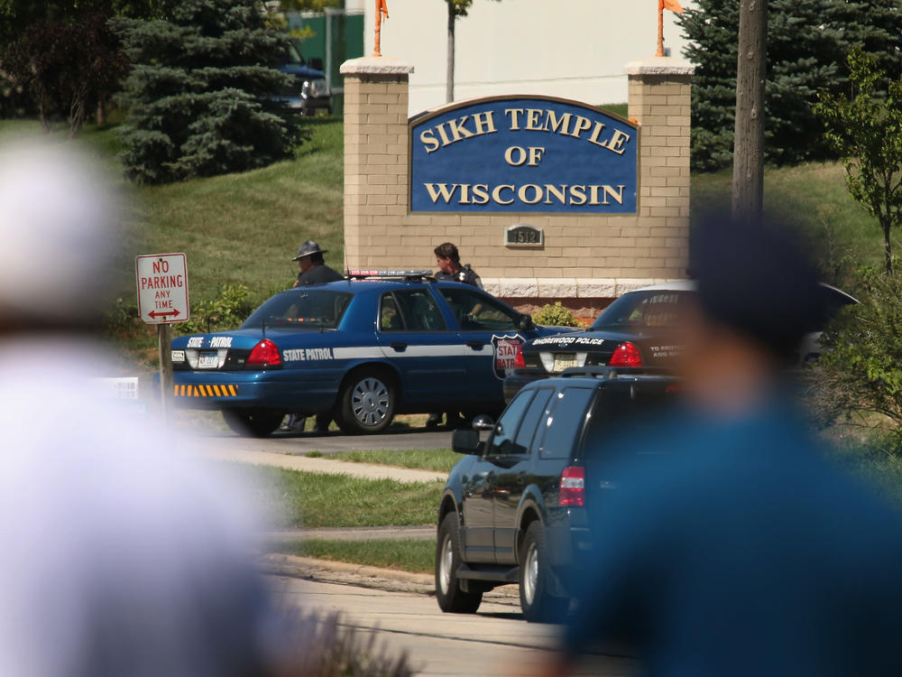 Police guard the front of the Sikh Temple of Wisconsin where at least one gunman fired upon people at a service August, 5, 2012 in Oak Creek, Wis. Six people were killed when a shooter, who was later shot dead by a police officer, opened fire on congregants in the Milwaukee suburb.