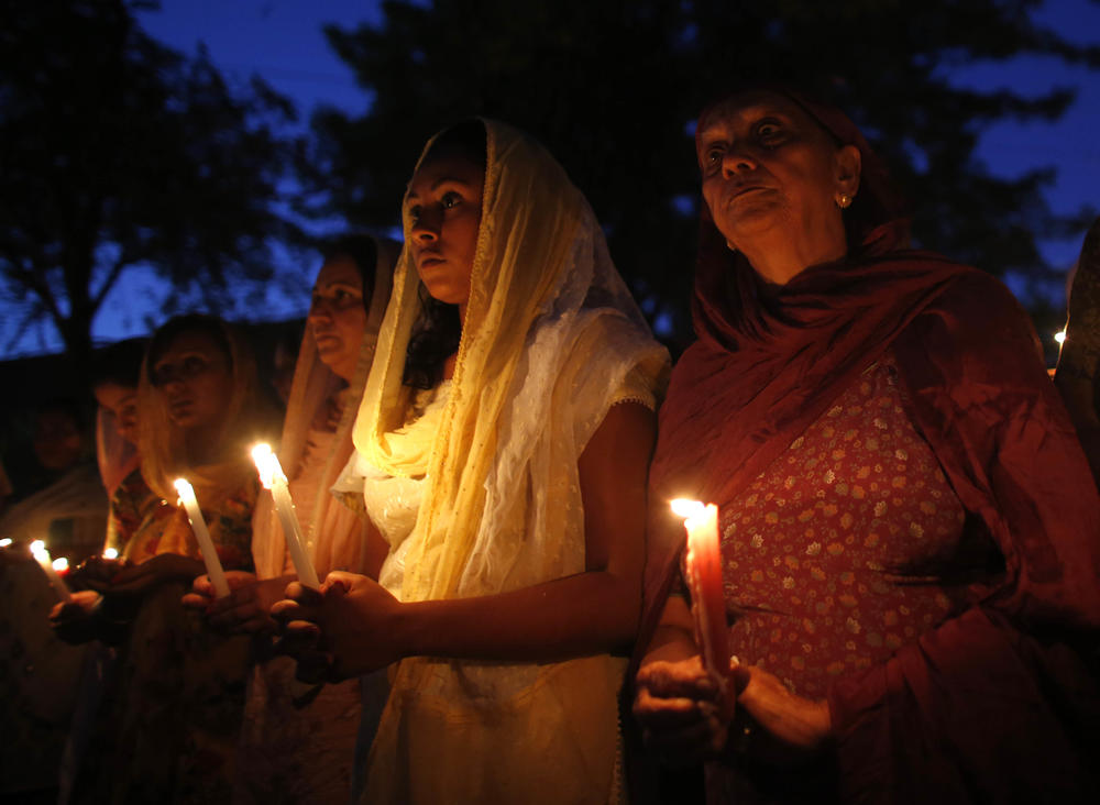 Members of the Sikh community along with other mourners attend a candlelight vigil at the Sikh Religious Society of Wisconsin for the victims of the shooting at the Sikh Temple of Wisconsin the previous day, on Aug, 6, 2012 in Brookfield, Wis. Wade Michael Page opened fire with a 9mm pistol at the Sikh Temple, killing six people before being killed by police in a shootout.
