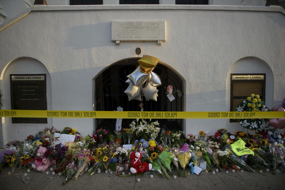 A morning view of a memorial outside the Emanuel AME Church June 19, 2015 in Charleston, S. C. Police arrested then-21-year-old, Dylann Roof, suspected of carrying out a gun massacre at one of America's oldest black churches, the latest deadly assault to fuel simmering racial tensions.