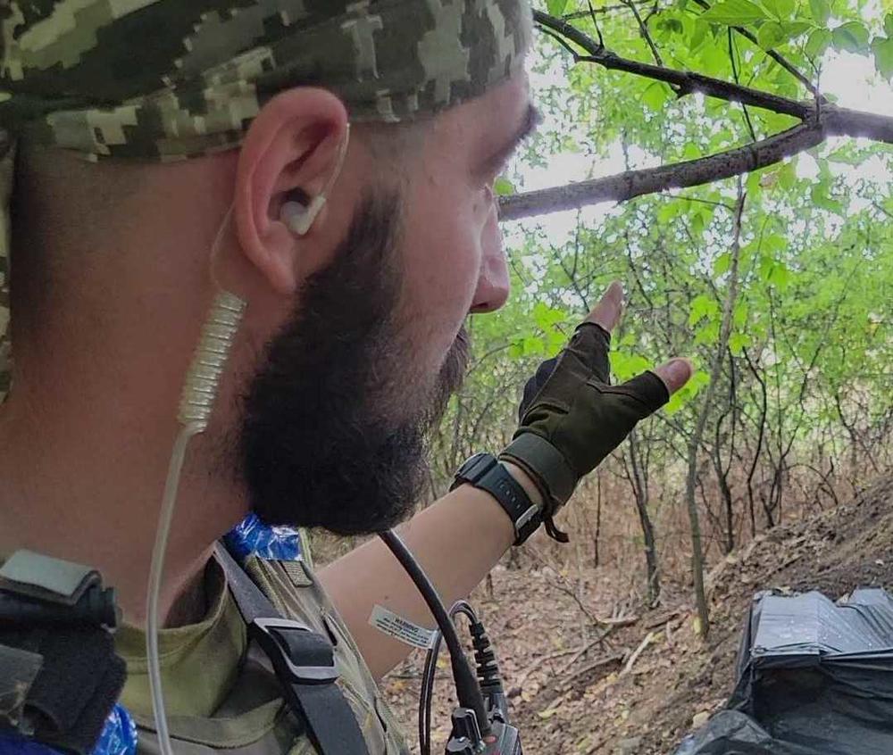 A Ukrainian soldier who identifies himself as Viktor points to the trench where he and fellow soldiers faced incoming Russian mortar and tank fire.