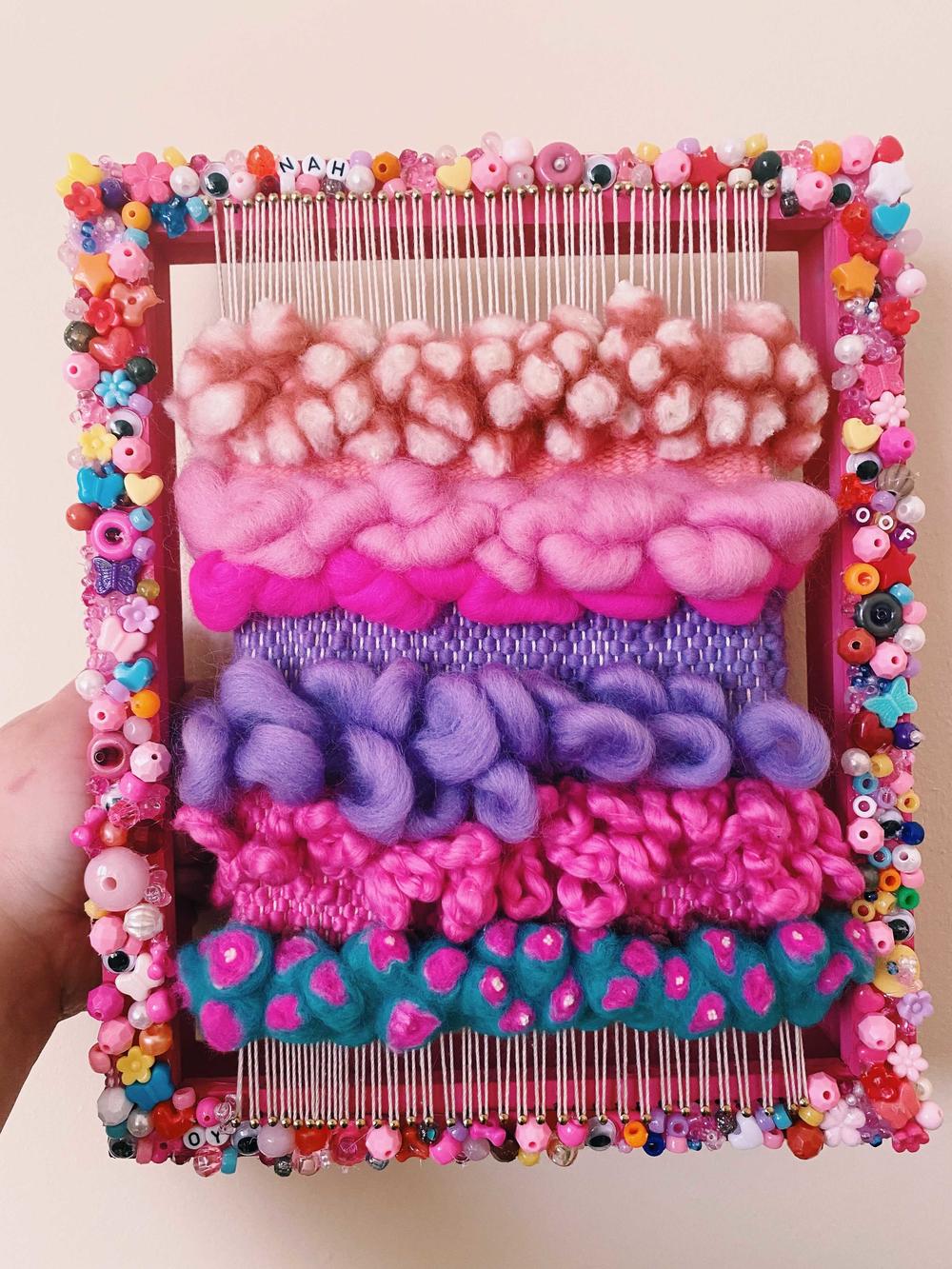 A weaving project on Natalie's bedazzled loom.