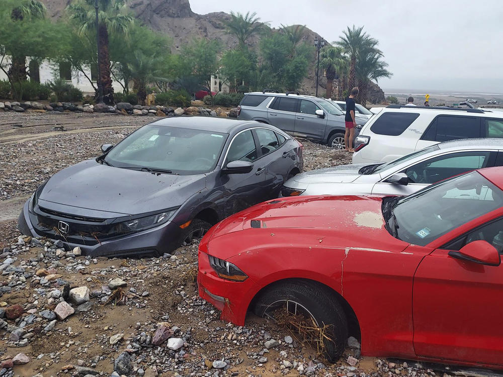 Cars are stuck in mud and debris from flash flooding at The Inn at Death Valley in Death Valley National Park in California on Friday.