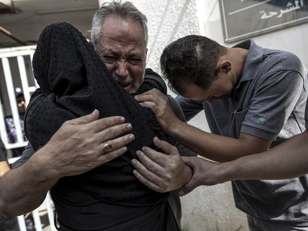 Relatives of Muhammad Hassouna, who was killed in an Israeli airstrike mourn before his funeral outside a hospital in Rafah, in the southern Gaza Strip, Sunday, Aug. 7, 2022.