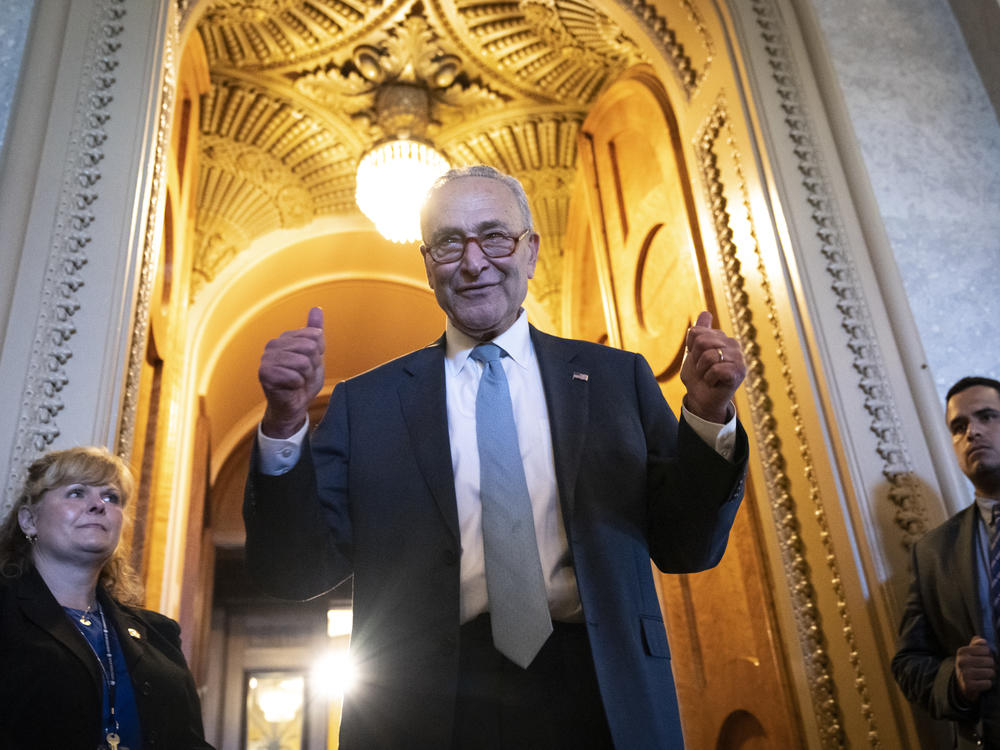 Senate Majority Leader Chuck Schumer gives the thumbs up as he leaves the Senate Chamber after passage of the Inflation Reduction Act on Sunday.