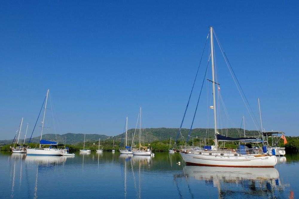 Neuman's boat, Symbiosis (center, background), in an anchorage in Luperón, Dominican Republic, in 2016.