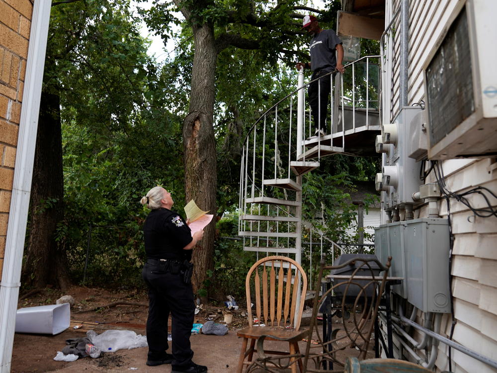 An Oklahoma County deputy serves a renter with a court summons notifying him of an eviction order in Oklahoma City, Okla., on Sept. 15, 2021.