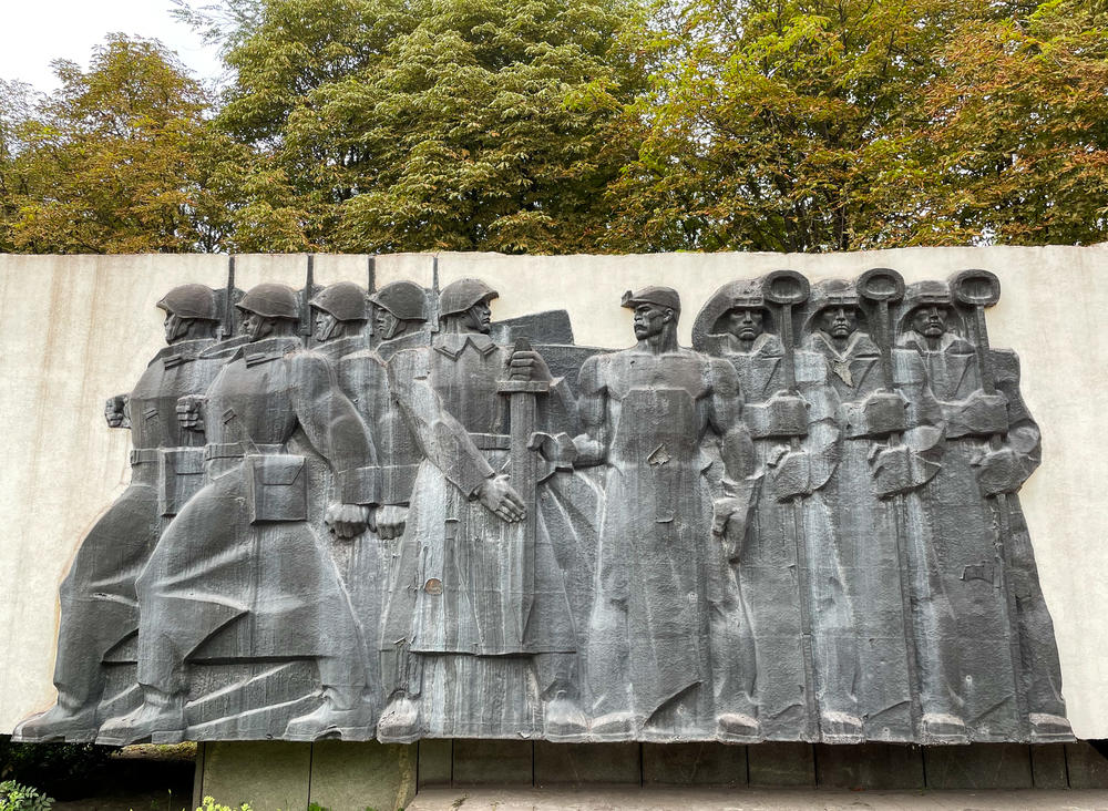 The Soviet-era mural in front of Zaporizhstal iron and steel works in Zaporizhzhia. The mural depicts iron workers handing a sword to soldiers.